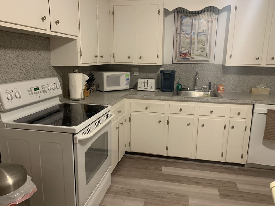 All new flooring throughout the house as seen here in this updated Kitchen photo