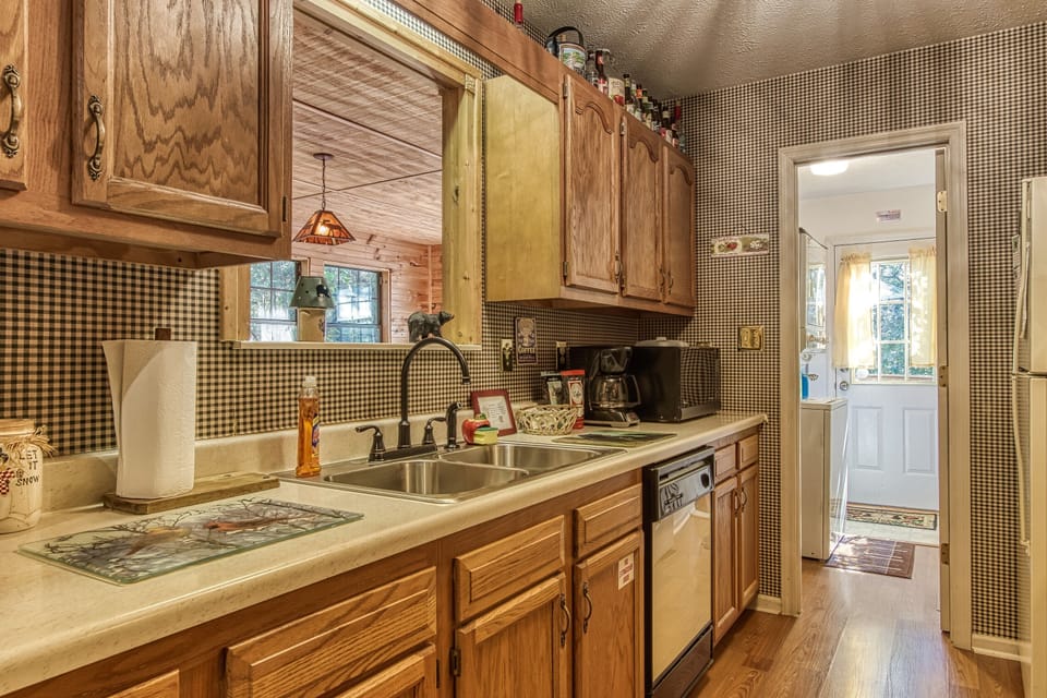 Overlook into the game room from the kitchen with adjoining laundry room.