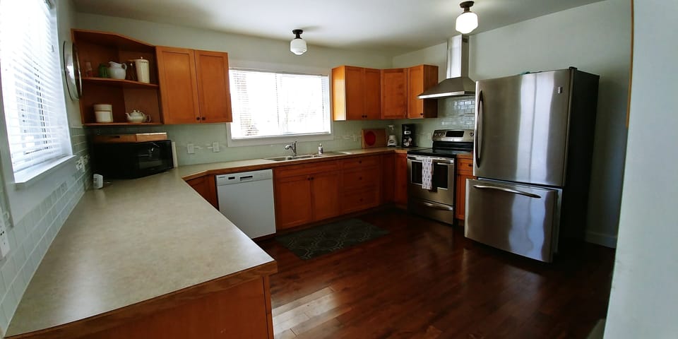 Large kitchen with ample supplies of dishes, pots and pans
