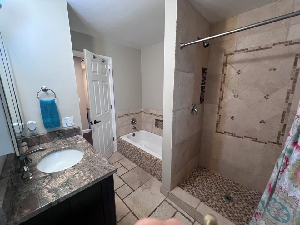 Second floor bathroom with separate tub and shower.
