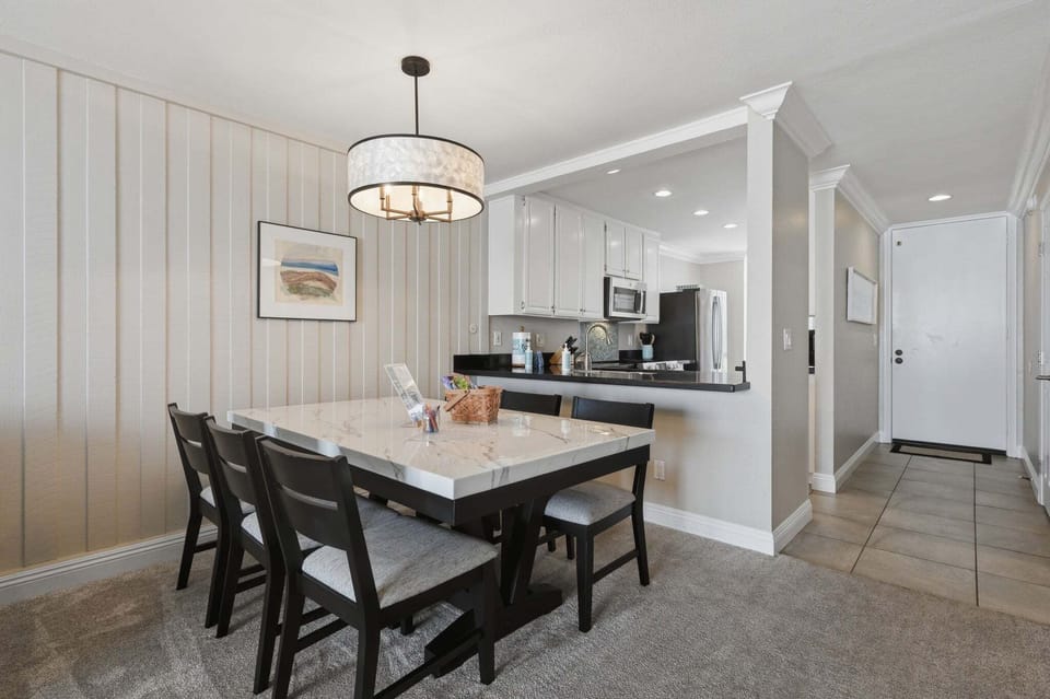 Comfortable dining setup seating for 6 with warm lighting and modern coastal charm