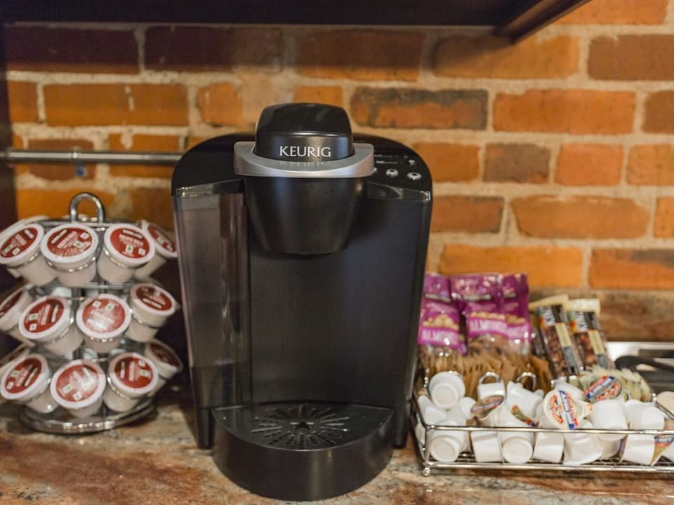 - Fully stocked coffee station with Keurig and essentials   - Brick backdrop enhances the cozy morning vibe   - Perfect for guests who love easy fresh brewed coffee