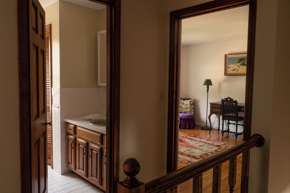View from the upstairs hallway - bathroom on left, primary suite on right.