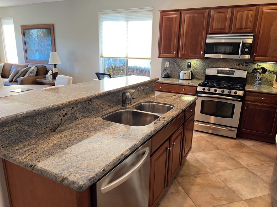 Kitchen area with double sinks and garburator. 
