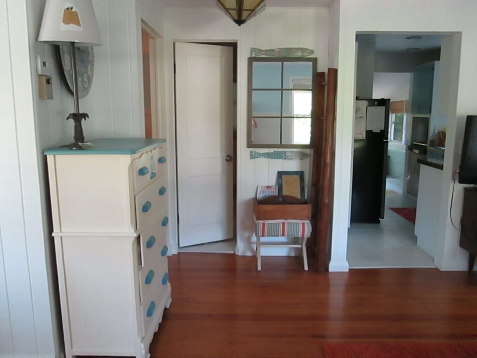 View to the kitchen/bathroom showing original 1950's pine floors