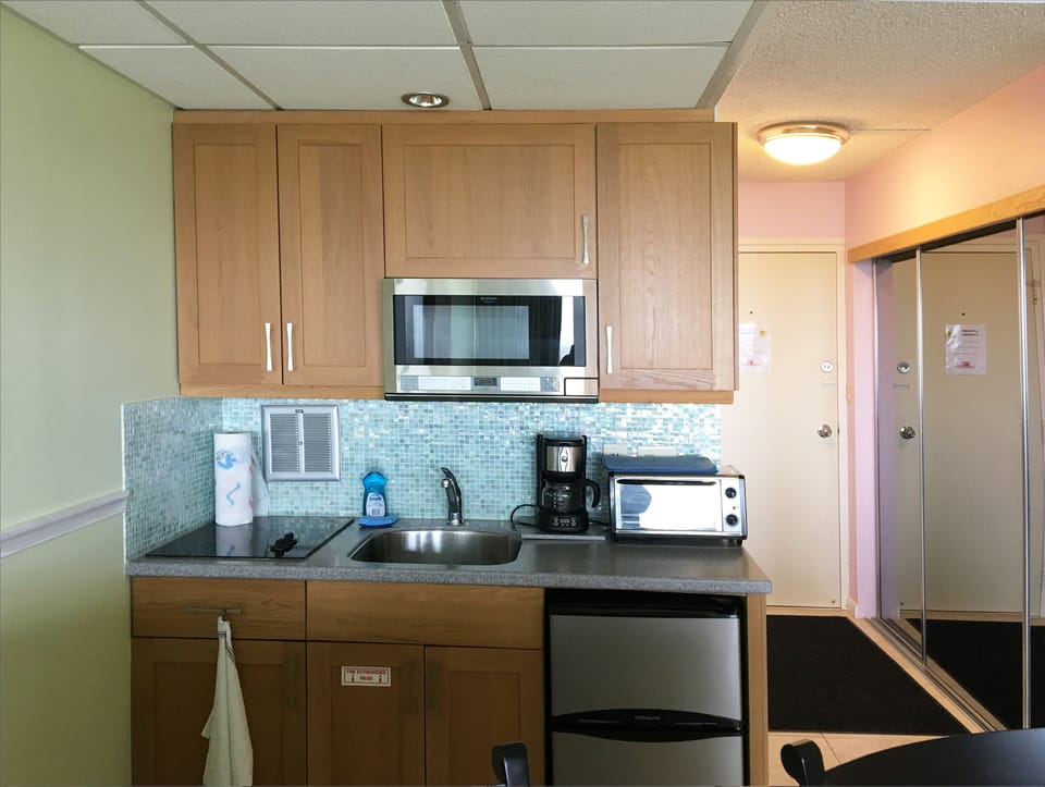2 burner stove, microwave, toaster oven, sink,  refrigerator/freezer, efficient