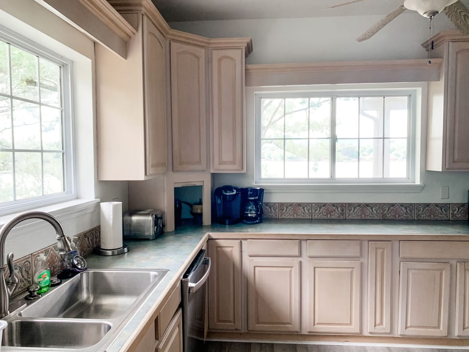 Lake views from and cabinets stocked for all of your cooking needs in kitchen. 
