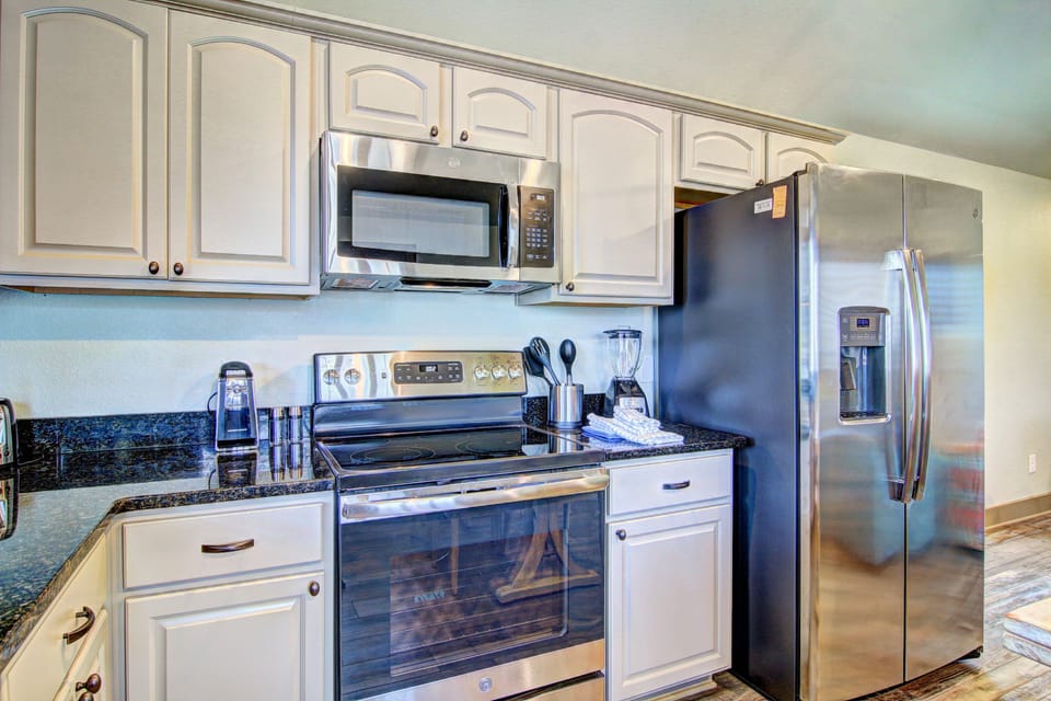 Kitchen - Experience culinary charm in this cozy vacation rental kitchen