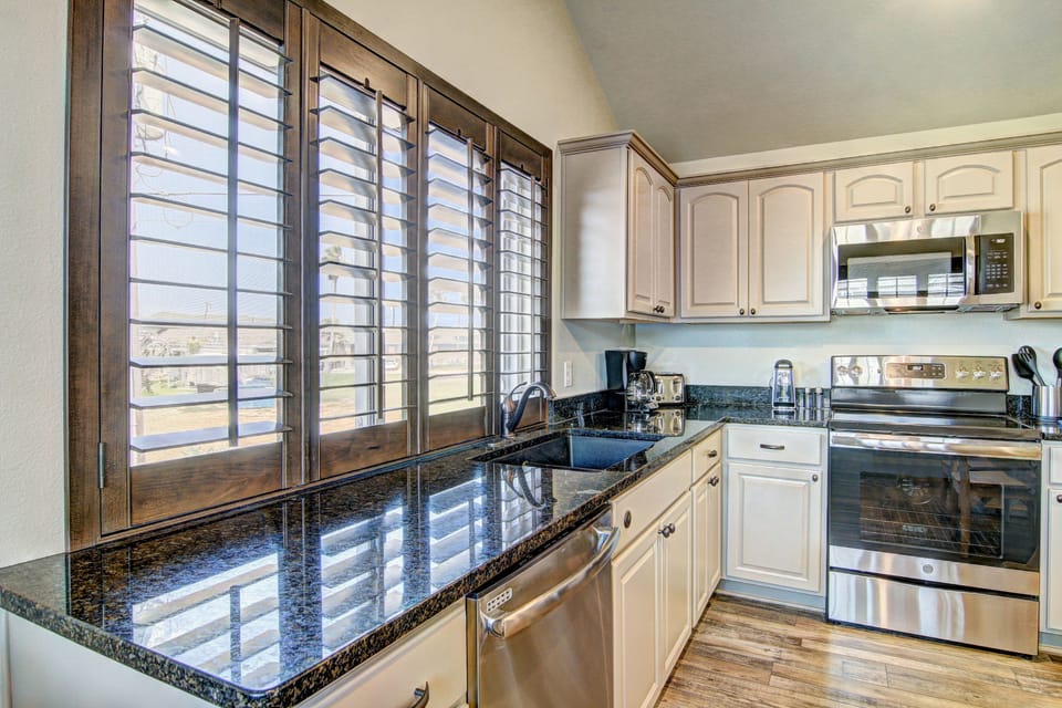 Kitchen - Open kitchen layout with plenty of counter space and coastal charm