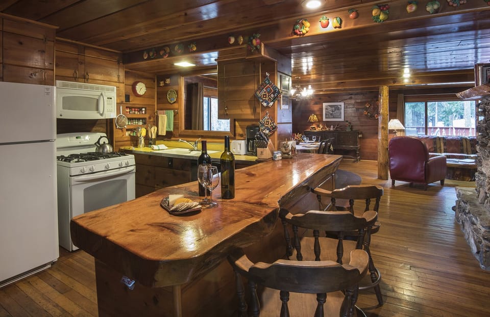 Kitchen has an open floor plan, and bar that will sit three.