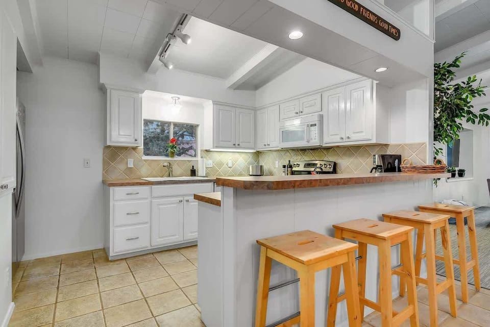 Kitchen area (complete with a sink, countertop, fridge, microwave, stove, utensils, coffee maker)