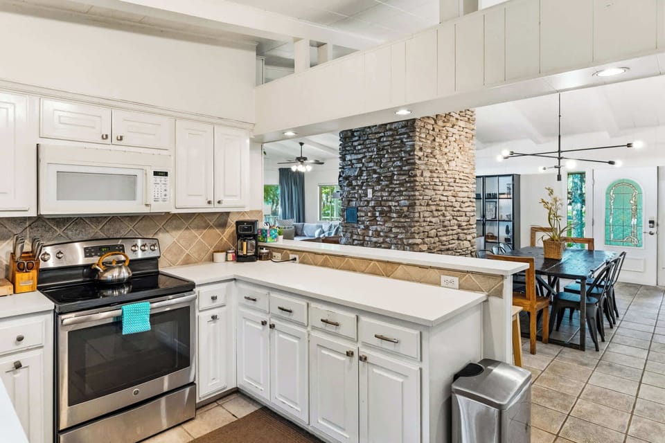 Kitchen area (complete with a sink, countertop, fridge, microwave, stove, utensils, coffee maker)