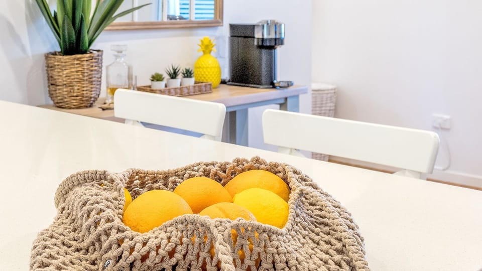 Bag of citrus on the dining set.