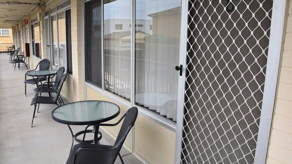 Table and chairs out the front of unit 8.