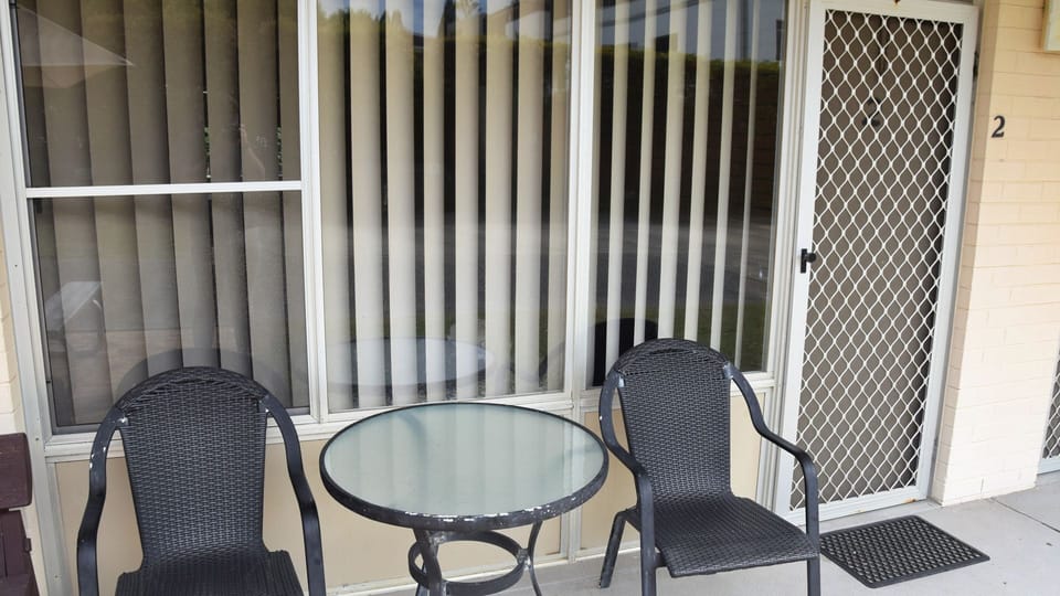 Table and chairs out the front of unit 2.