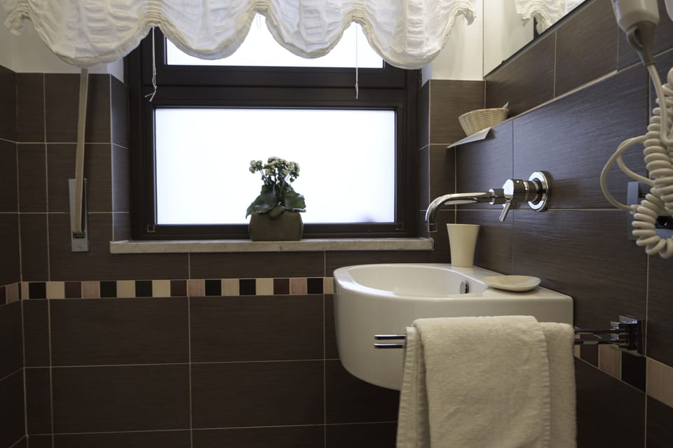 Quadruple Room | Bathroom | Shower, free toiletries, hair dryer, slippers