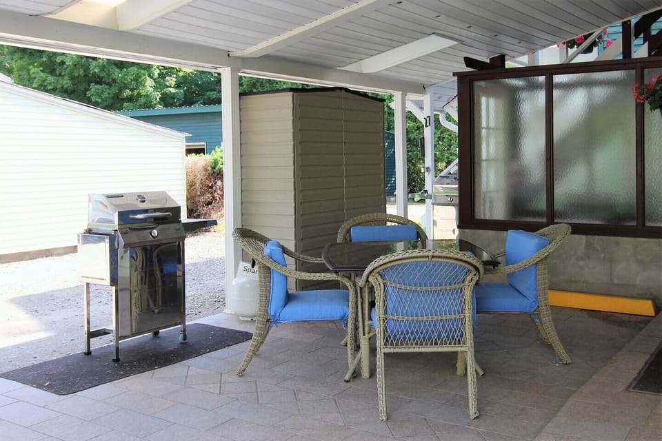 Covered patio with gas grill for relaxing after a long day at the ball field.