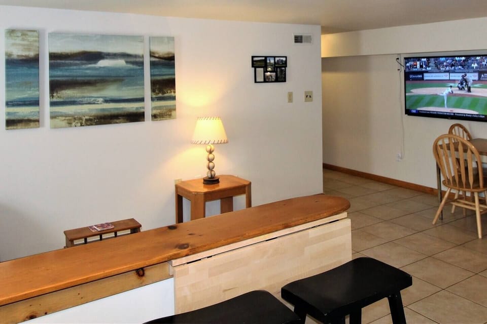 55" (or larger) wall mounted flat screen smart Roku TV.  Watch from the living room, while dining, or even from the kitchen!  Never miss a moment of the game or your favorite show.