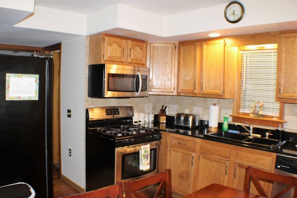 Kitchen with stainless steel gas range, microwave and dishwasher