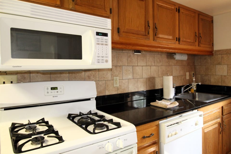 Gas range, full size microwave oven and dishwasher