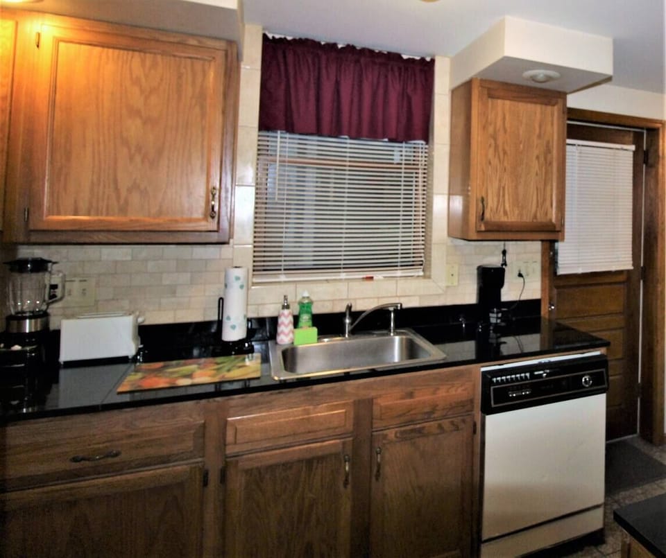 Kitchen with granite countertops and flooring.  Lots of appliances for all the comforts of home
