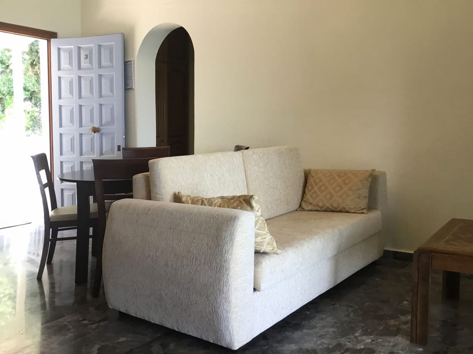 Apartment, 1 Bedroom, Sea View (03) | Living area | Flat-screen TV