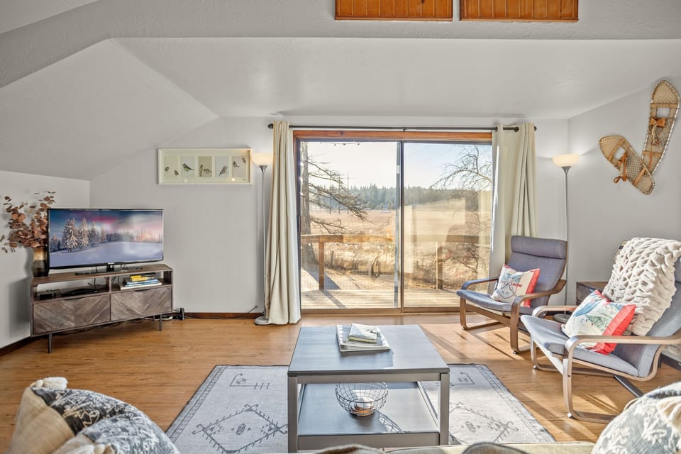 Living room. Looking from couch out front balcony.