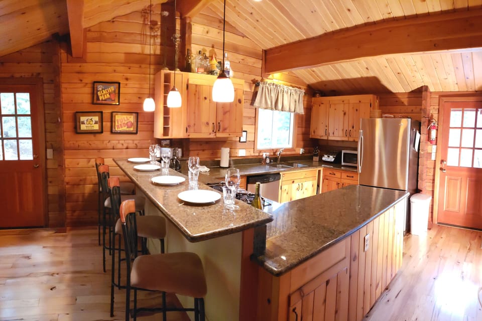 Well stocked kitchen with breakfast bar. Great counter space for a buffet.