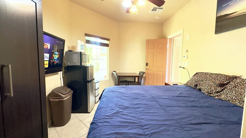 Cozy furnished studio — table, seating, and private entrance with smart lock