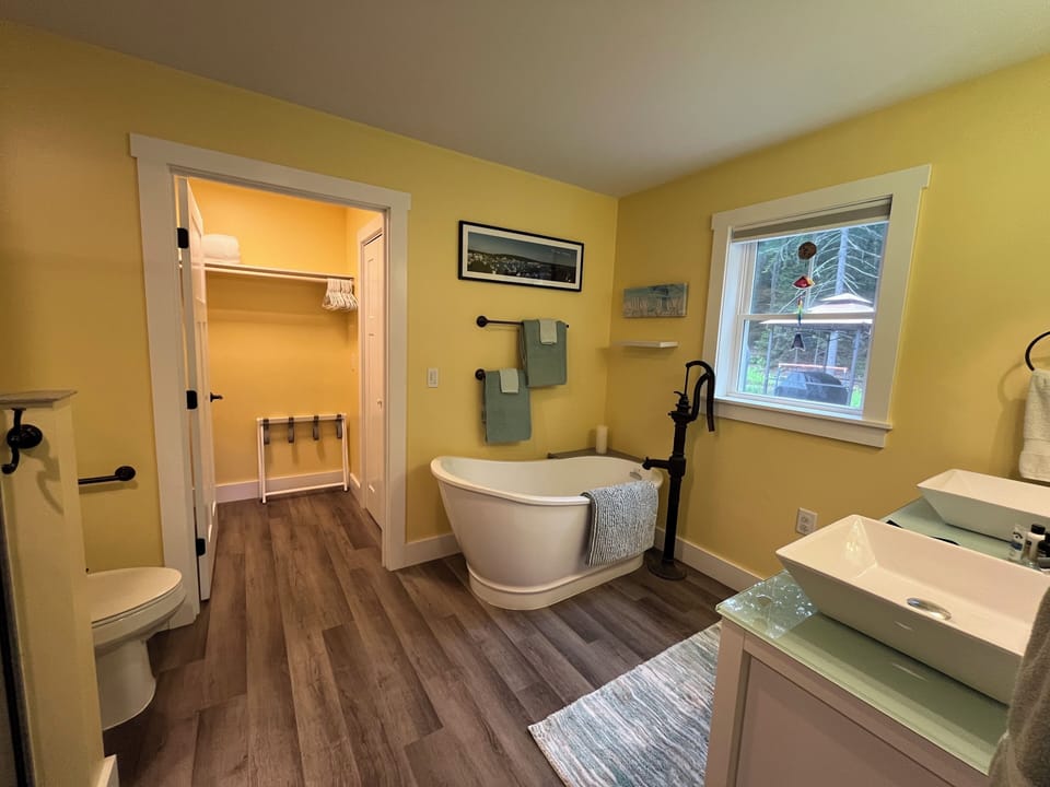 Master bathroom with slipper tub, double vanity and walk in shower and closet. 