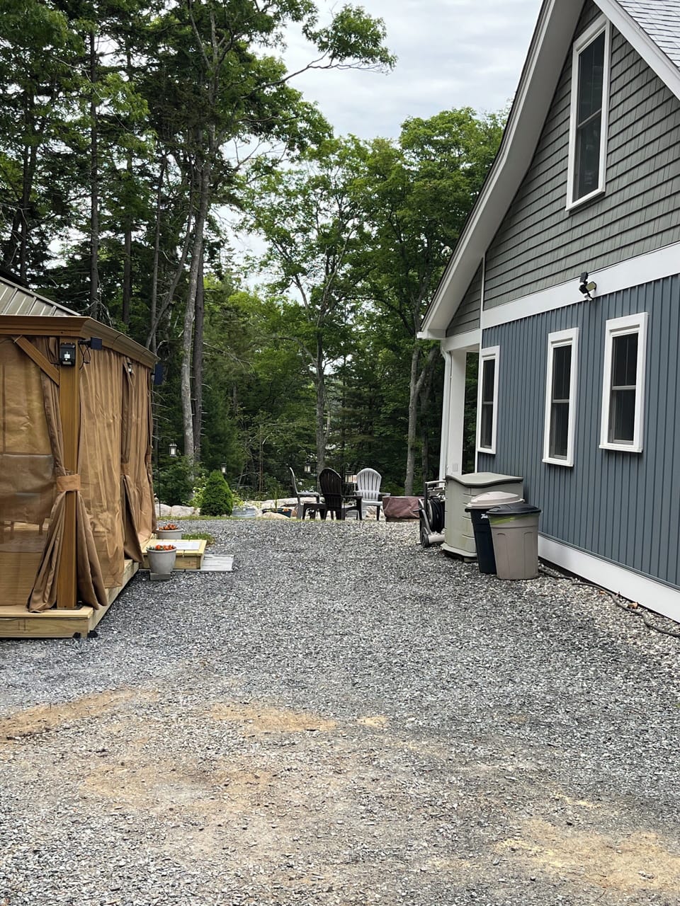 Side view of home with gazebo, rubbermaid shed w/ extra camping chairs for beach