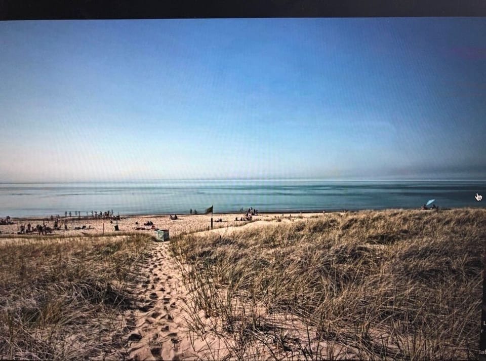 True lakefront property, steps to beach with giant lush grass backyard