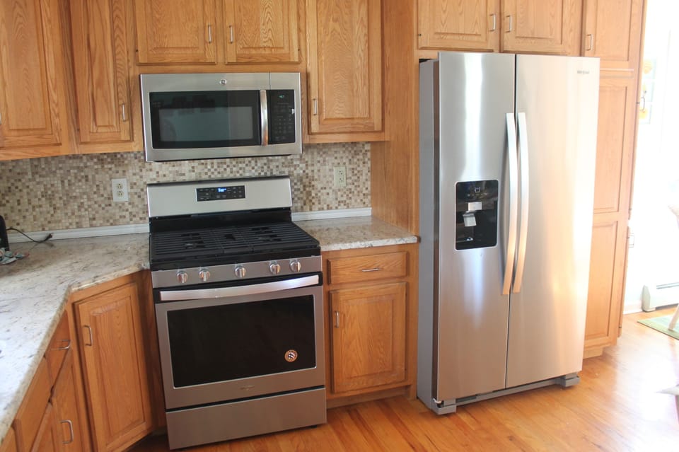 Gas stove, microwave, and refrigerator.