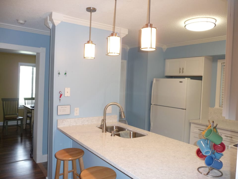 Fully stocked kitchen has granite countertops and full size appliances.