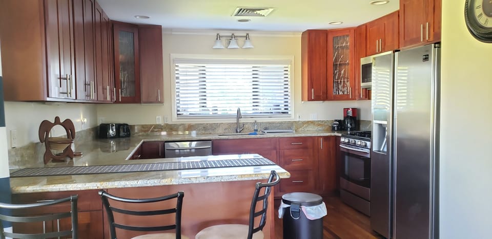 Gourmet kitchen w/ dishwasher; microwave, refrigerator and range/oven.