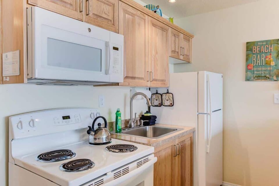 The full kitchen has the works: range oven, stove top, refrigerator, microwave, and all the cookware and dishes you need for the Anthony Bourdain in your party.