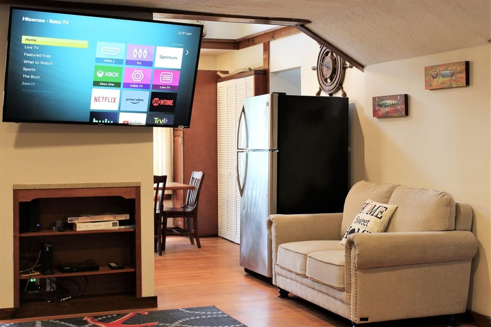 Large 55" (or larger) flat screen smart Roku TV in the living room with cable
