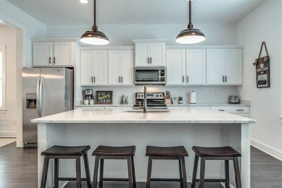 Kitchen fully stocked with all cooking essentials, oven, dishwasher, microwave, stove and drop coffee maker