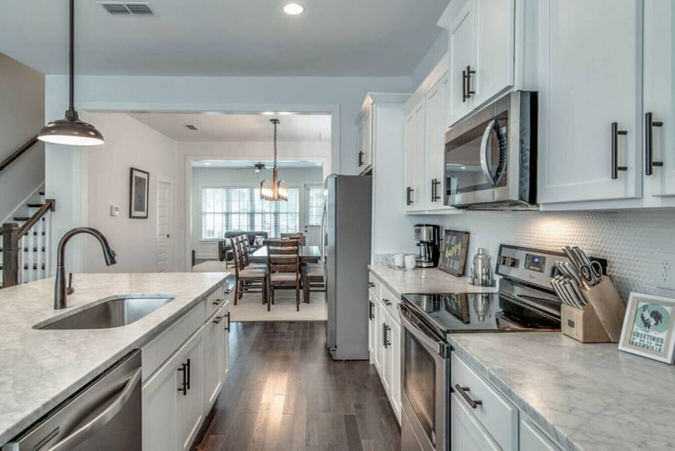 Kitchen fully stocked with all cooking essentials, oven, dishwasher, microwave, stove and drop coffee maker