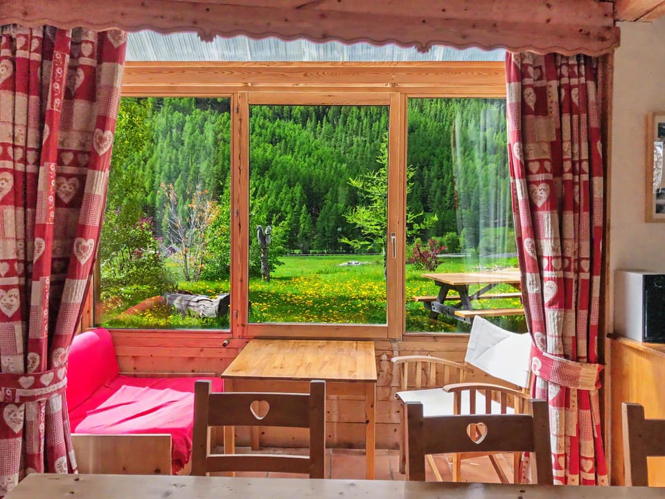 Bright interior with table and direct mountain view.