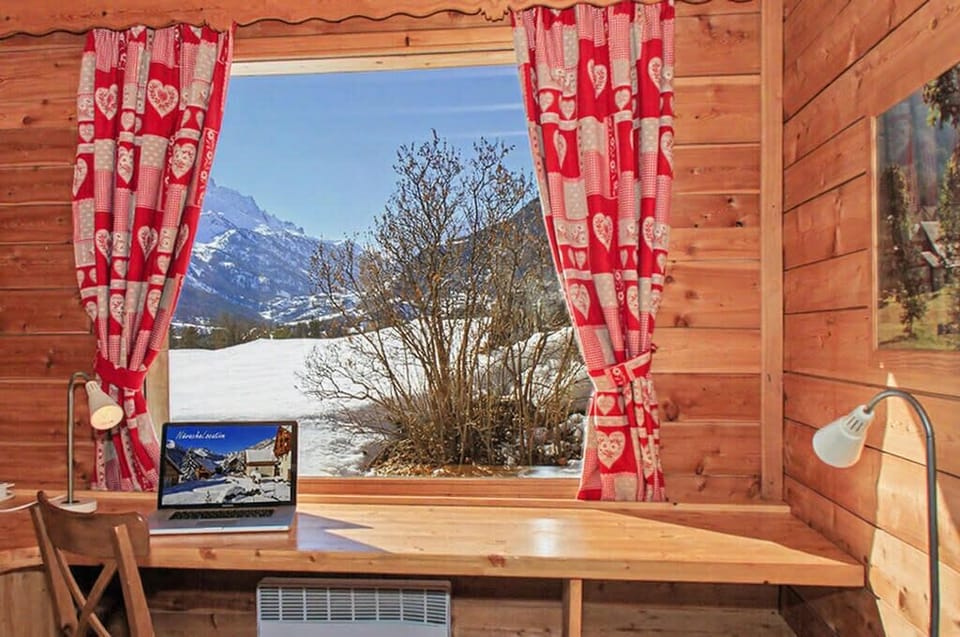 Bright desk area with view of the snowy mountains.