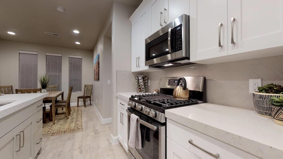 Fully Stocked Gourmet Kitchen Featuring Stainless Steel Appliances and tea kettle