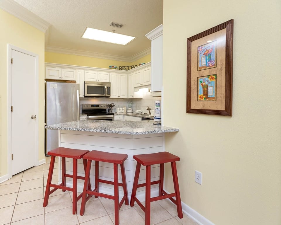 Gather with friends at the breakfast bar, surrounded by cheerful decor and a stylish kitchen design