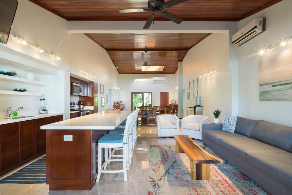 The house has a large open living, dining area that looks out onto the ocean