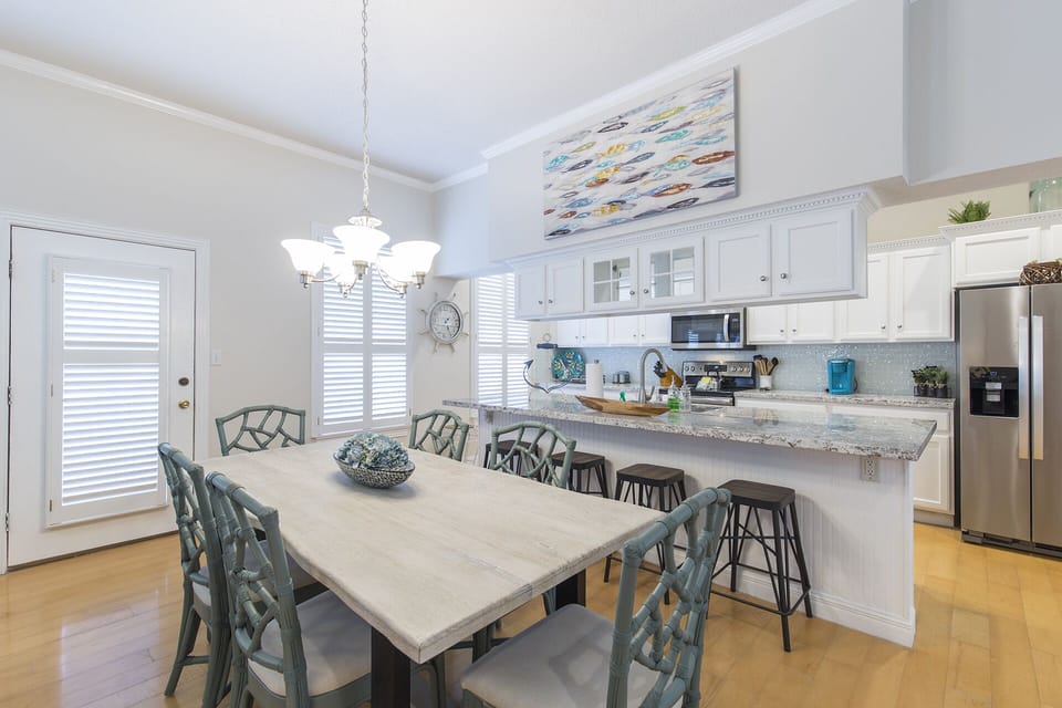 Great dining table for family meals with extra seating for guests at the kitchen counter.