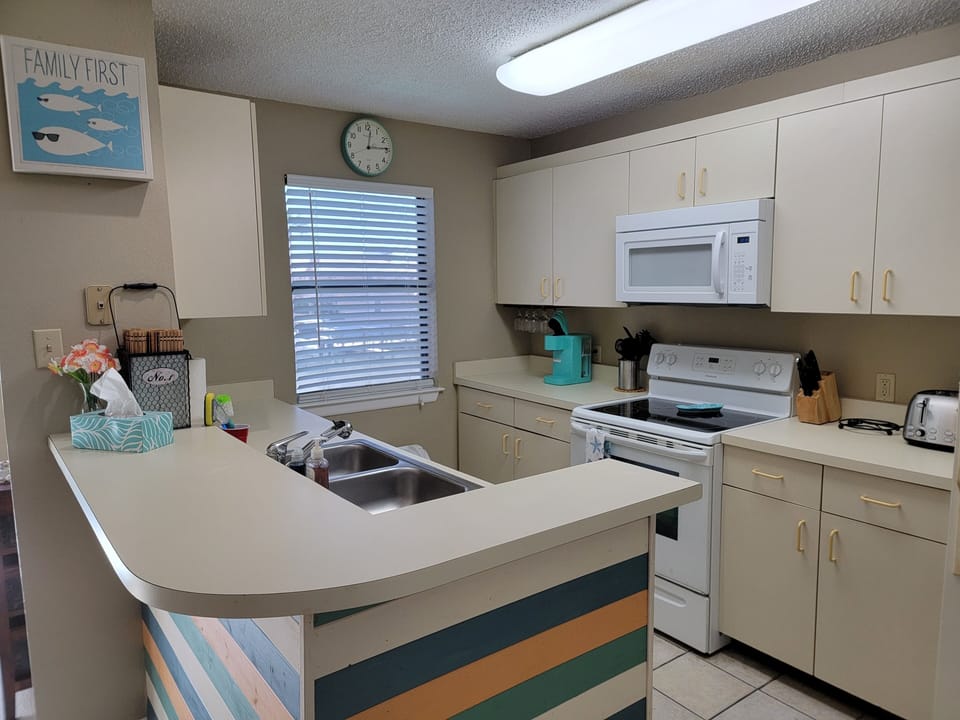 Fully equipped kitchen has everything needed for cooking and dining.