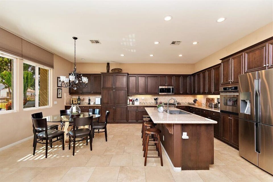 Large gourmet kitchen with dining table and center island 
