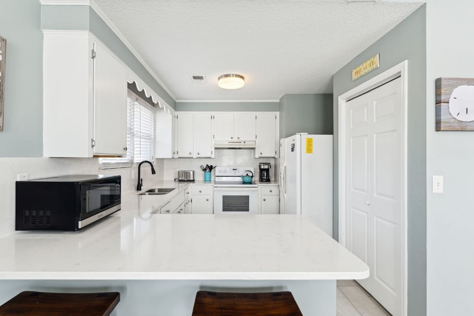 Breakfast bar and kitchen area view form dining area