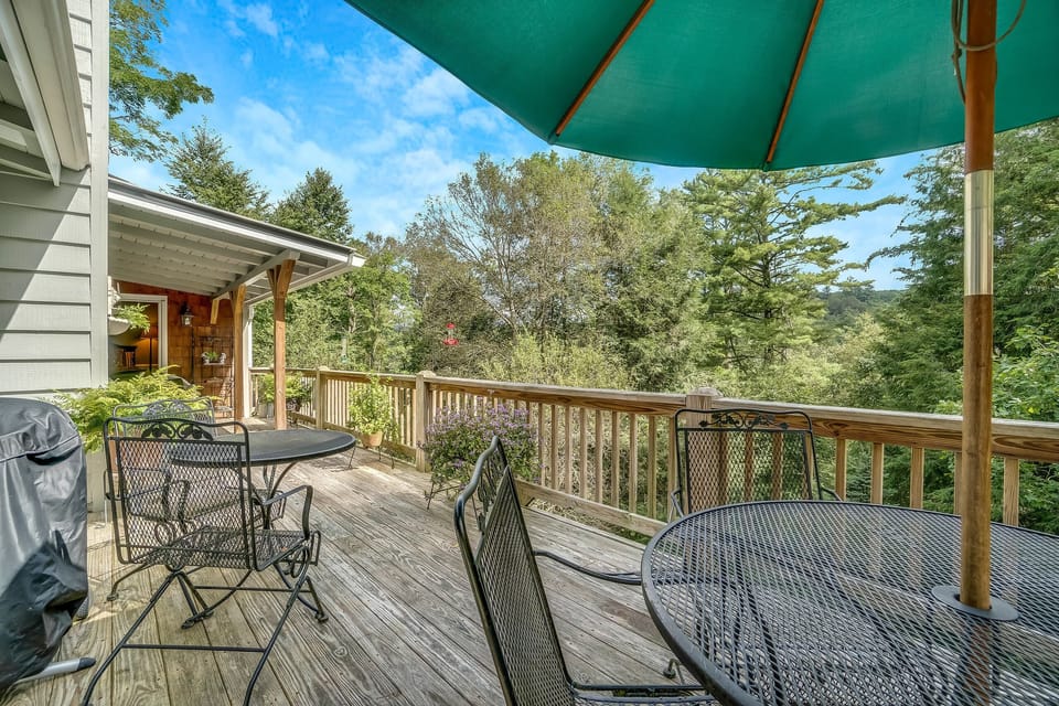 Back Porch with two wrought iron tables and chairs. Electric grill on porch