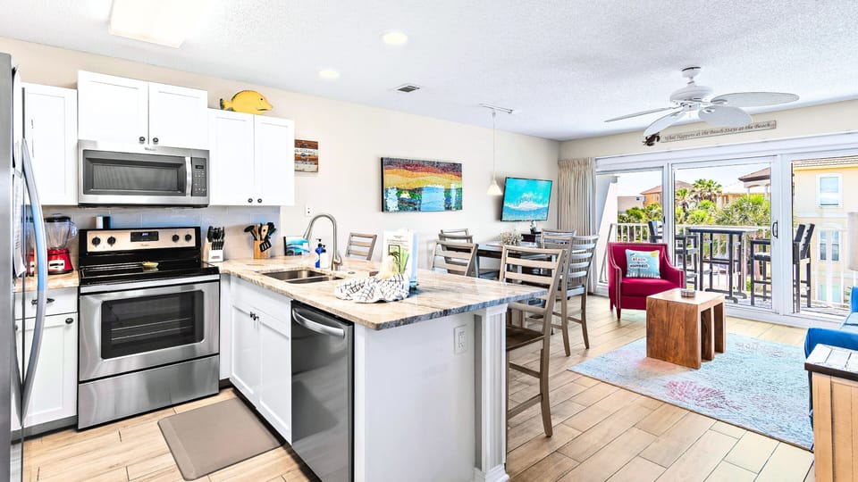 The renovated kitchen opens to the bright living space.